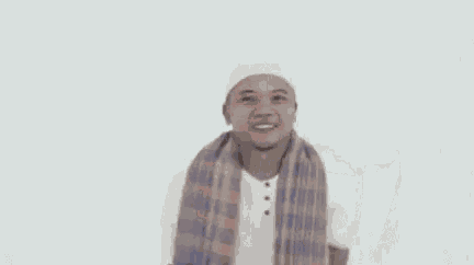 a man with a scarf around his neck and the words kang rusmanaan kabitaeun