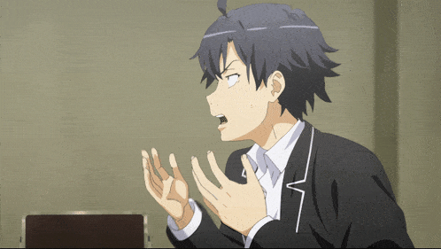 a man in a black suit and white shirt is making a funny face