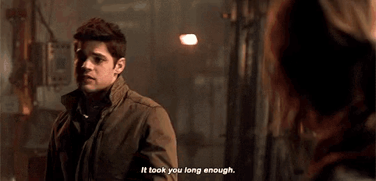 a man is talking to a woman in a dark room and saying `` it took you long enough . ''