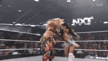 two women are wrestling in a ring with nxt written on the bottom