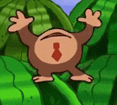a cartoon monkey with a red tie is standing in a field of green leaves .