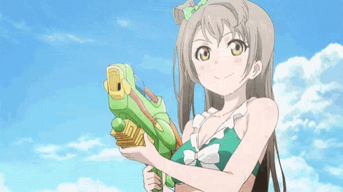 a girl in a bikini is holding a water gun in her hands .