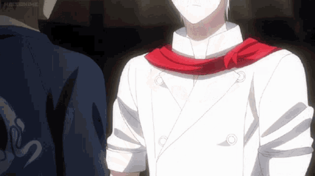 a man in a chef 's uniform with a red scarf around his neck