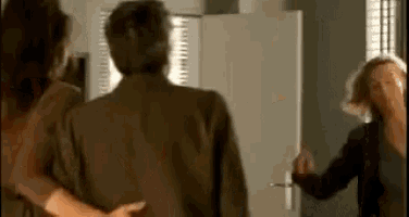 two women are standing next to each other in a room .
