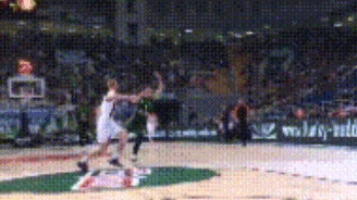 a basketball game is being played in a stadium with a few advertisements