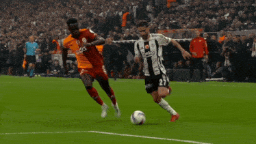 a soccer player wearing a number 27 jersey kicks the ball