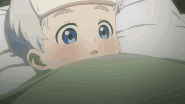 a little boy with a thermometer on his forehead laying in bed