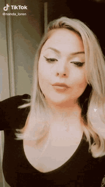 a woman 's face is shown in a tiktok video taken by nanda loren