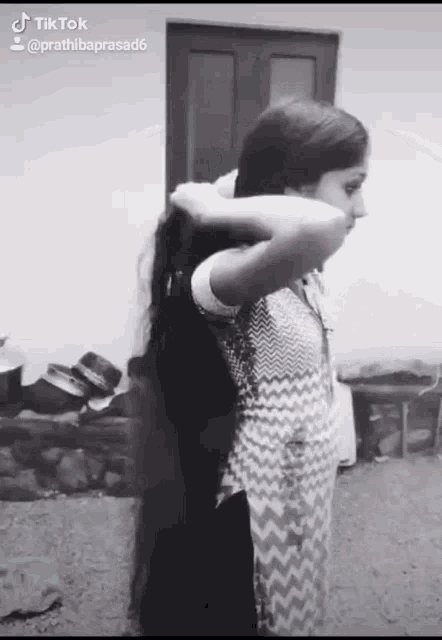 a black and white photo of a girl with long hair taken by tiktok