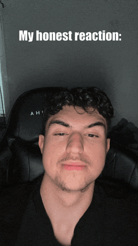 a man is sitting in a chair with the words my honest reaction