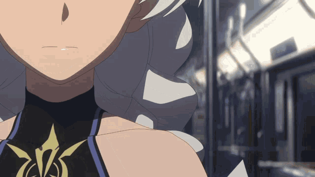 a close up of a girl 's face with a black top with a yellow emblem on it