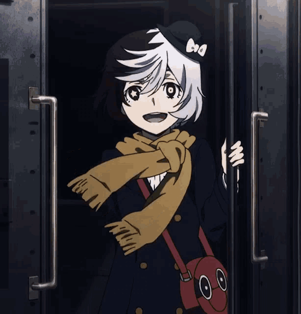 a girl wearing a scarf and a hat with the letter a on it