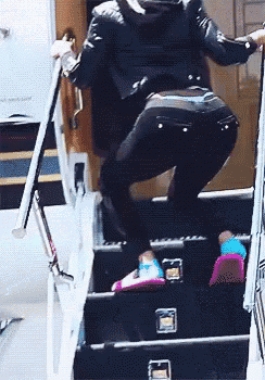 a person is walking up a set of stairs with a sign that says ' stairs ' on them