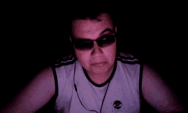 a man wearing sunglasses and a shirt that says ' pink ' on it