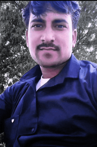 a man with a mustache is wearing a blue shirt and white shirt