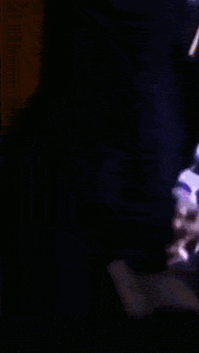 a blurred image of a person 's face with a purple and orange background