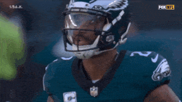 a football player wearing a helmet with eagles on it