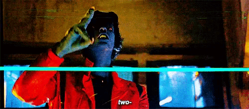 a pixelated image of a man with a red jacket that says two on it