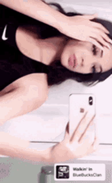 a woman is taking a selfie with her phone