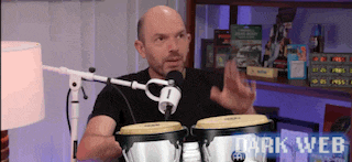 a bald man is playing drums in front of a microphone and the words dark web are on the bottom