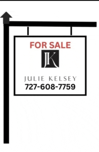 a for sale sign for julie kelsey 727-608-7758