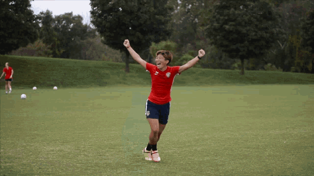 a soccer player in a red shirt with the u.s. flag on it