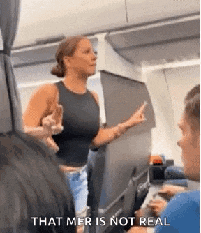 a woman is giving the middle finger on an airplane while a man looks on .