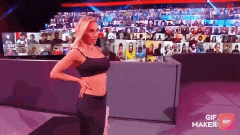 a woman is standing on a stage in front of a large screen .