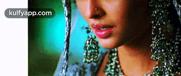 a close up of a woman 's face with a nose ring .