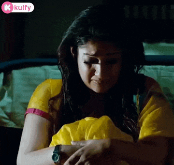a woman in a yellow shirt is crying while holding a yellow blanket .