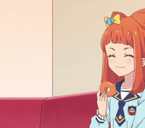 a girl with a crown on her head is holding a donut in her hand