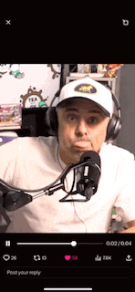 a man wearing headphones and a hat is talking into a microphone on a cell phone .
