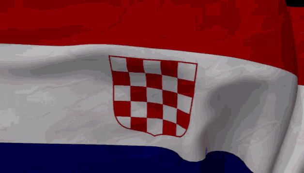 a red white and blue flag with a checkered emblem