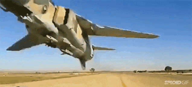 a fighter jet is taking off from a runway and flying through the air .