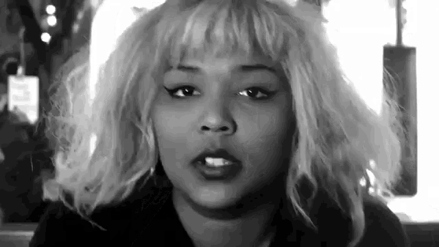 it is a black and white photo of a woman with blonde hair .