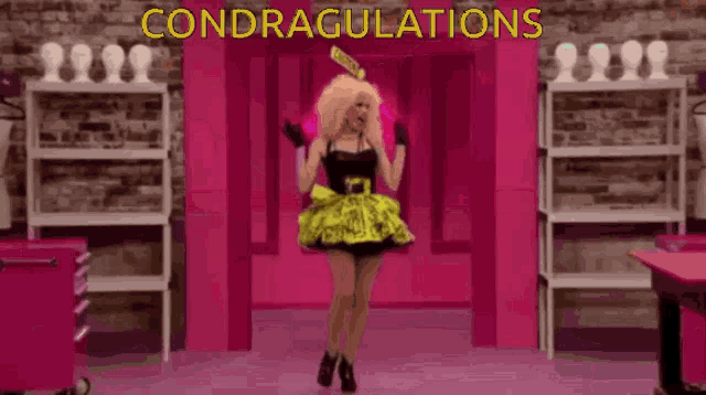 a woman in a yellow and black dress is dancing in front of a sign that says congratulations
