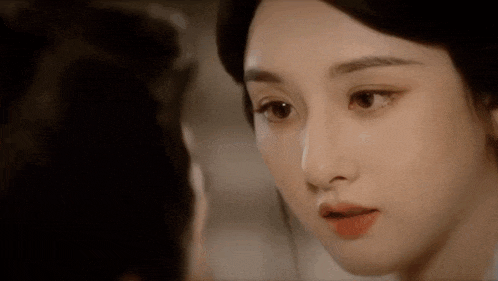 a close up of a woman 's face looking at another woman .