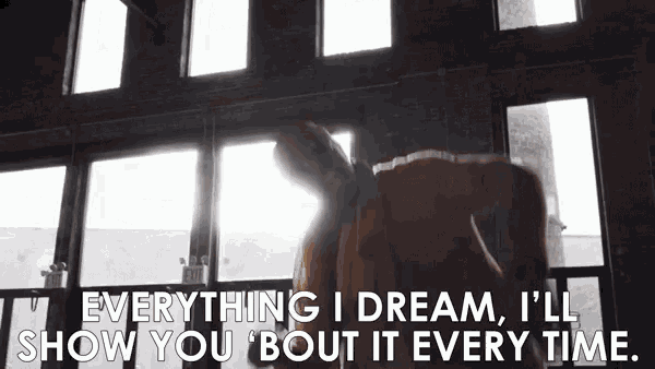 a man is standing in front of a window with the words `` everything i dream , i 'll show you bout it every time ''