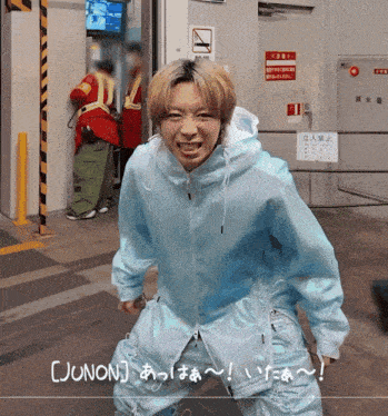 a man in a blue jacket with junon written on the bottom