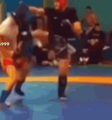 a blurry picture of a wrestling match with the year 1999 on the bottom
