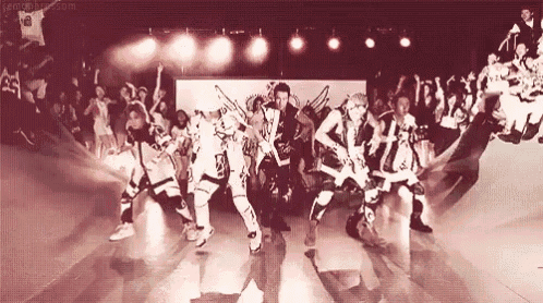 a group of people are dancing on a stage with a crowd behind them and a watermark that says ' gentleman '