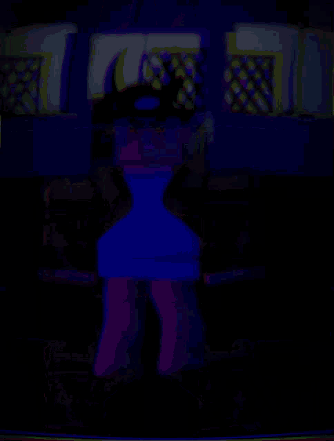 a blurry image of a person standing in a dark room with a blue light behind them