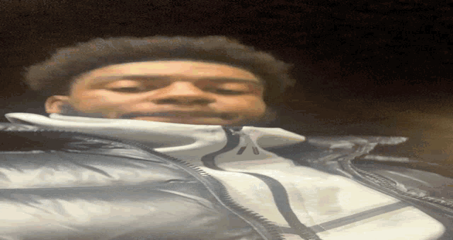 a man wearing a jacket with a zipper on it