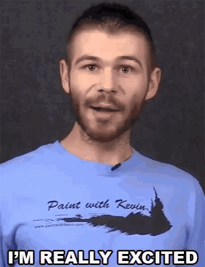 a man with a beard wearing a blue shirt that says i 'm really excited .