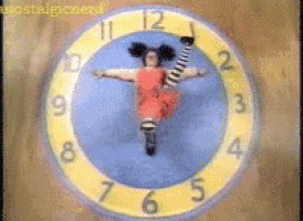 a clock with a girl in a red dress and striped socks