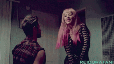 a woman with pink hair is standing next to a man with reiduratani written in the corner
