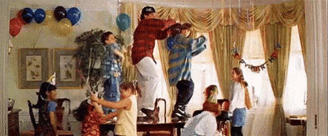 a group of people are jumping in the air at a birthday party .
