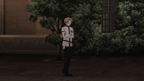 a man with his arms crossed in front of a building