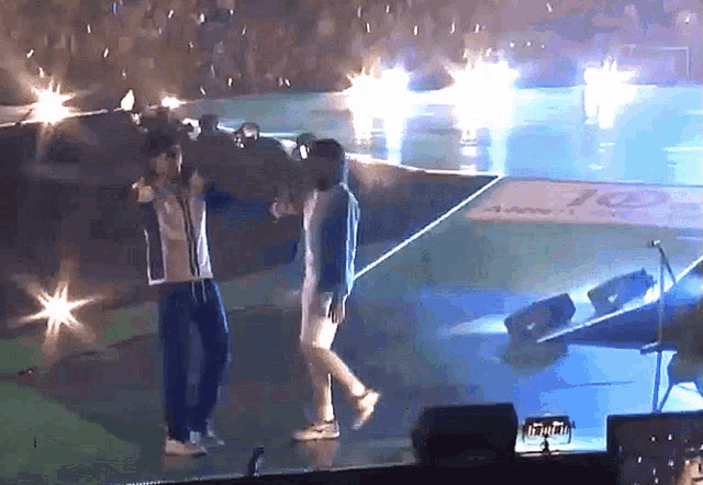 a man and a woman are dancing on a stage in front of a sign that says 10