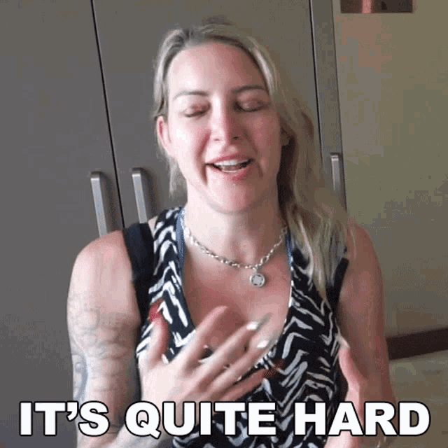 a woman says it 's quite hard in a black and white dress
